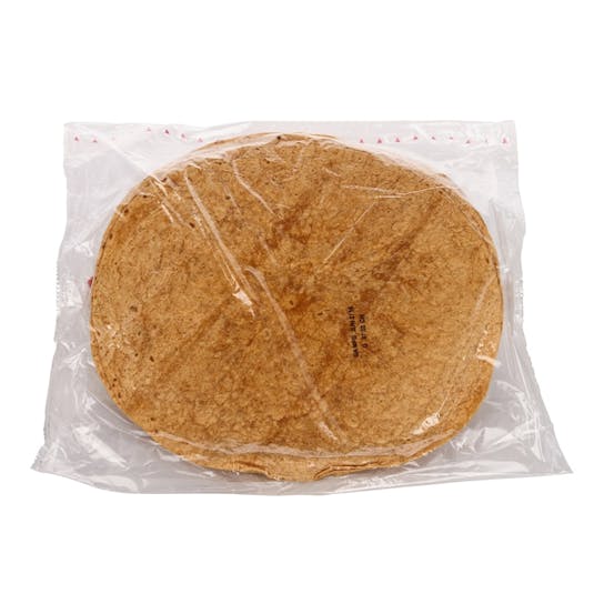 A stack of brown tortillas packaged in a transparent plastic bag, placed against a white background.