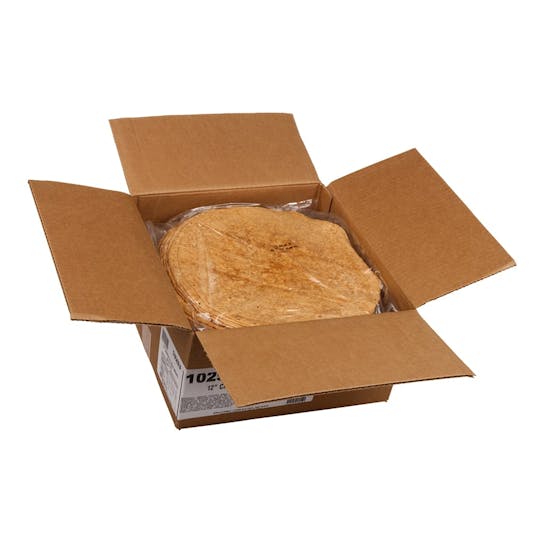 An open cardboard box containing a stack of round tortillas wrapped in clear plastic. The tortillas are light brown and the box flaps are spread outward.