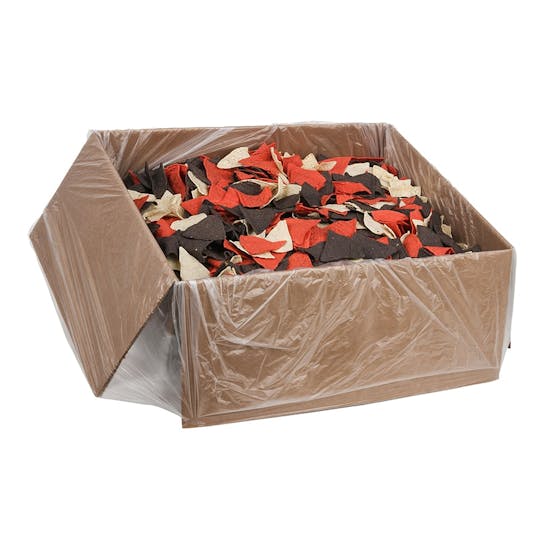 A large cardboard box lined with clear plastic, filled with red, yellow, and blue tortilla chips mixed together.