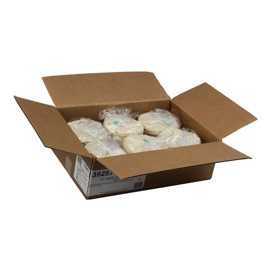 An open cardboard box containing several stacks of round tortillas wrapped in clear plastic bags, placed on a white background.