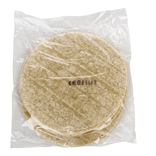 A clear plastic vacuum sealed package containing several round, flat flour tortillas stacked on top of each other.